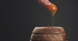 © GCapture - man plunging finger in honey pot to taste it