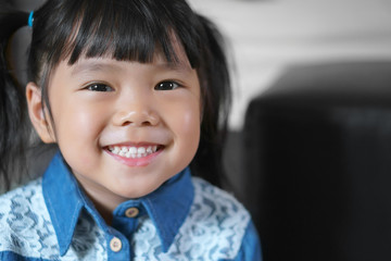 Wall Mural - Asian children cute or kid girl wearing jeans or cowboy suit for fashion and smile white teeth with small eye and happy for background with space