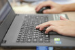 © kornnphoto - hand of businessman on computer notebook keyboard for working and internet playing or check email on table at office