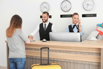 Young woman near reception desk in hotel