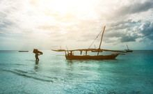 Old Rustic Fishing Boat Sitting In The Ocean, Calm And Still Turquoise Waters, Zanzibar