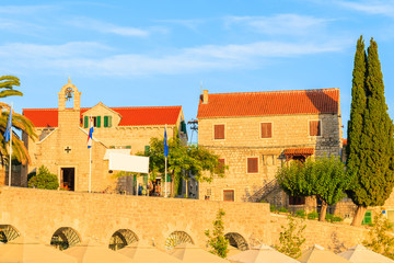 Wall Mural - View of typical old houses and church in Bol port at sunset time, Brac island, Croatia