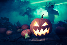 Spooky Halloween Pumpkin On Dark Field With Scarecrows