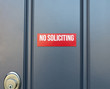 No soliciting red sign on residential front door of home