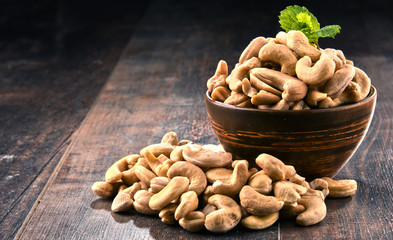 Wall Mural - Bowl with cashew nuts on wooden table