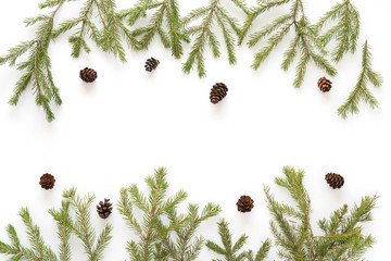 Wall Mural - Christmas tree branches and cones on white background, top view. New Year's background. Christmas background. 