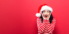 Happy Young Woman With Santa Hat On A Solid Background