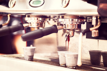 coffee machine. coffee machine preparing fresh coffee and pouring into two cups at restaurant, bar or pub, toned in vintage style