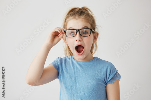 Little Beautiful Girl With Bright Blue Eyes And Blonde Hair Posing