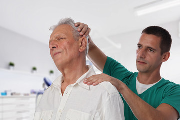 Wall Mural - Man having chiropractic back and neck adjustment. Osteopathy, Alternative medicine, pain relief concept. Physiotherapy, sport injury rehabilitation