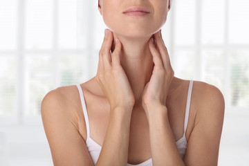 Close up of female neck and shoulders. Woman thyroid gland control.