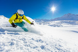 Fototapeta Panele - Skier skiing downhill in high mountains
