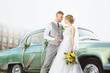 © Africa Studio - Happy wedding couple near decorated car outdoors