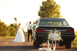 © Africa Studio - Car with plate JUST MARRIED and happy wedding couple outdoors