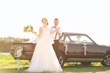 Sticker - Happy wedding couple near decorated car outdoors