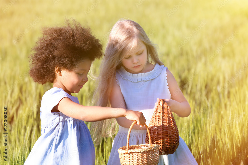 Happy little girls in green field