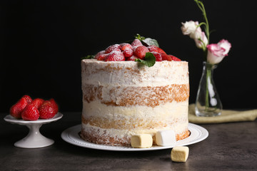 Delicious strawberry cake on table