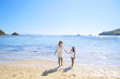 © Creativa Images - Young woman with daughter in the beach