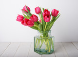 Fototapeta Tulipany - bunch of red tulip flowers  in a glass vintage jar