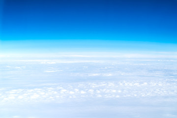 Wall Mural - blue sky and cloud top view from airplane window,nature background