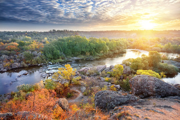 Wall Mural - mountain river among stony shores in the evening