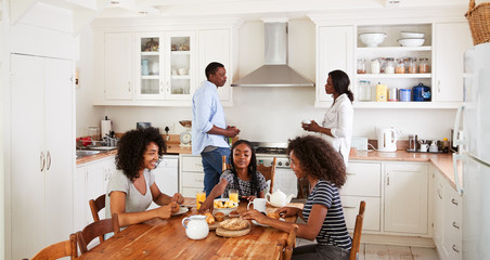 Poster - Family With Teenage Children Eating Breakfast In Kitchen