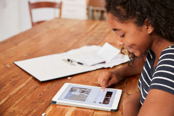 Poster - Teenage Girl With Digital Tablet Revising For Exam At Home