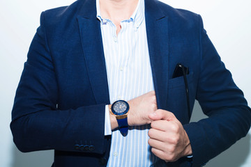 Wall Mural - Businessman in suit close-up.Fashion portrait of young businessman handsome model man in casual cloth suit with accessories on hands