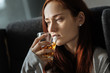 © Viacheslav Yakobchuk - Unhappy moody woman drinking whisky