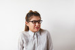 © shurkin_son - Negative human expressions, emotions, feelings, reaction and attitude. Studio shot of young Caucasian female employee wearing glasses and formal shirt, grimacing, having displeased disgusted look