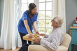 © Monkey Business - Nurse serving dinner to a senior man in an armchair at home