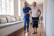 © Monkey Business - Nurse helping senior woman use a walking frame