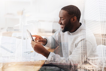 Wall Mural - Excited African American using a tablet