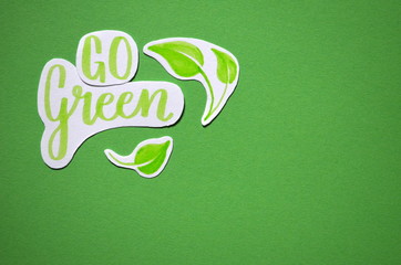 GO GREEN watercolour brush calligraphy on paper with leaves