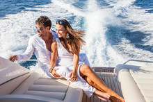 Couple Relaxing On Yacht, On Water, Looking At View