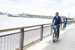 © Connect Images - Young businessman cycling on waterfront, New York, USA