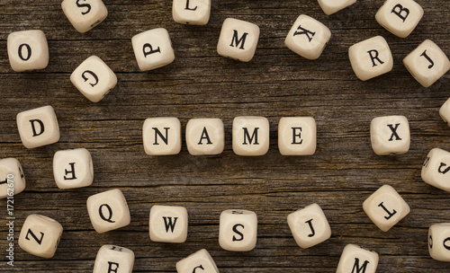 Fotomural Word NAME written on wood block