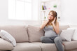© Prostock-studio - Pregnant woman listening to music in headphones