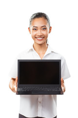 Cute Asian young smiling girl holding and showing laptop isolated