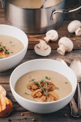 Wall Mural - Cream soup puree with mushroom on wooden background
