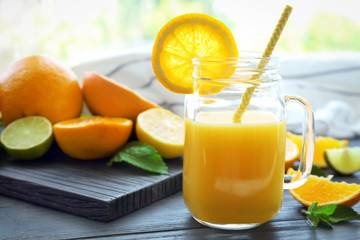 Mason jar of fresh orange juice on table