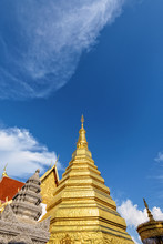 Wat Phra That Cho Hae Buddhism Temple With Golden Pagoda On Blue Sky Background. Places Worship Of Buddhists And Attractions Famous Religion At Phrae Province, Thailand