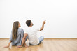 © realstock1 - The sitting couple look the empty wall and gesture