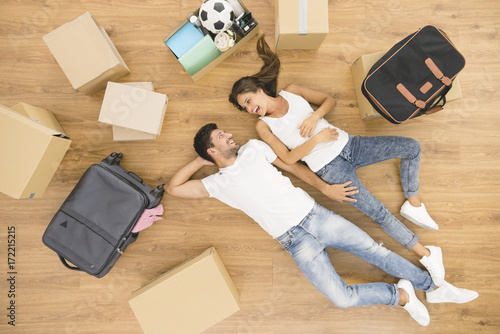 beautiful couple lay on the floor near