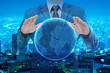 businessman in blue suite holding virtual globe with night city background