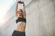 © Liubov Levytska - Young sporty female stretching before workout looking alive. Everyday workout can help you get things done.