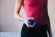 © Marija Mandic/Stocksy - Woman in sportswear holding a set of weight