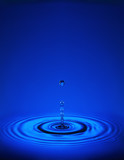 Fototapeta Łazienka - Droplet with ripples in blue liquid