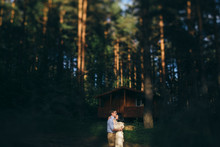 Young Couple Embracing In The Spotlight In The Forest