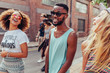 © Jacob Lund/Stocksy - Happy multiracial teenagers walking on the street